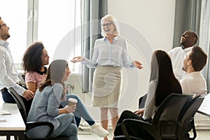 Female business coach leader and team people laughing at training