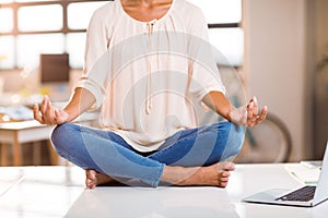 Female business executive performing yoga