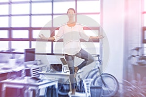 Female business executive performing yoga