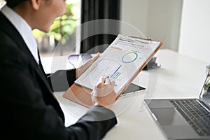 Female business financial worker reading and analysing a financial report