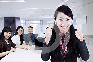 Female business leader with her team in office