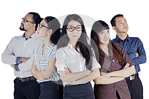 Female business leader with her team in the studio