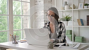 Female business owner engeneer working on invest laptop in modern office. saleswoman