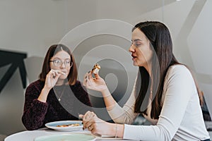 Successful female business employees enjoying a refreshing lunch break together.