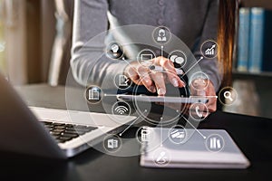 Female businesswoman or Designer using tablet with laptop on desk at home office .