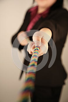 Female businesswoman pulling rope