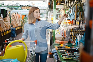 Female buyer with cart in shop for gardeners