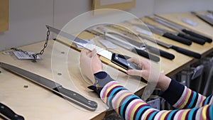 Female Buying New Kitchen Knife in a Store