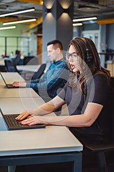 Female call center operator talking seriously on the headset