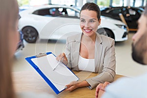 Female car dealer in showroom