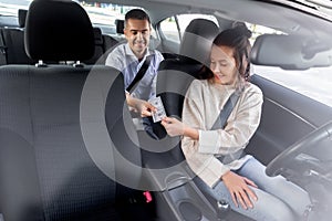 female car driver taking money from passenger