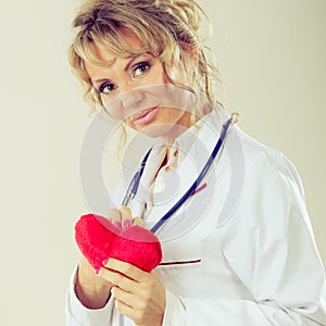 Female cardiologist with red heart.