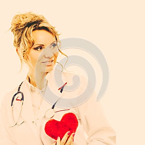 Female cardiologist with red heart.