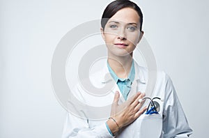 Female cardiologist touching with hand on chest photo