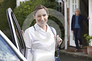 Female Care Worker Visiting Senior Woman At Home