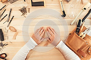 Female carpenter hands on work desk, top view