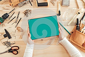 Female carpenter using digital tablet computer, mock up screen photo