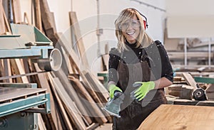Female carpenter Using Electric Sander