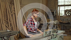 Female carpenter using power tools at her workshop