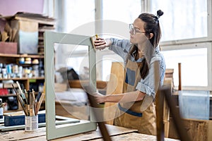 Female carpenter working in her workshop