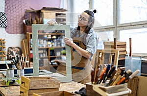 Female carpenter working in her workshop