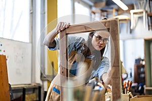 Female carpenter working in her workshop