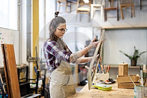 Female carpenter working in her workshop