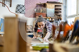 Female carpenter working in her workshop