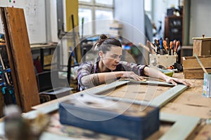 Female carpenter working in her workshop