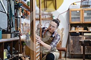 Female carpenter working in her workshop