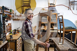 Female carpenter working in her workshop