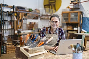 Female carpenter working in her workshop