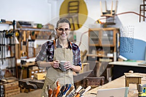 Female carpenter working in her workshop