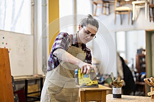 Female carpenter working in her workshop