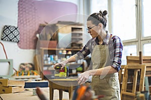 Female carpenter working in her workshop