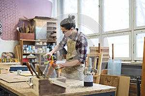 Female carpenter working in her workshop