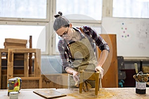 Female carpenter working in her workshop