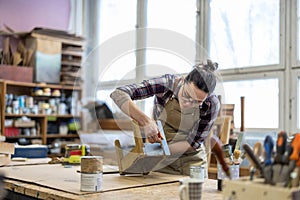 Female carpenter working in her workshop