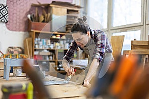 Female carpenter working in her workshop