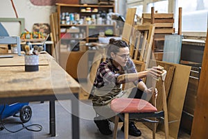 Female carpenter working in her workshop