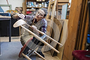 Female carpenter working in her workshop