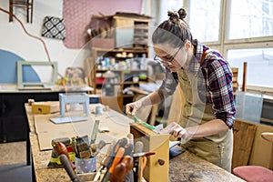 Female carpenter working in her workshop