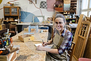 Female carpenter working in her workshop