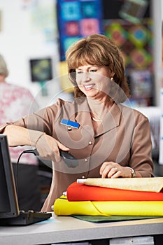 Female Cashier At Clothing Store