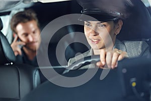 Female chauffeur driving a limousine