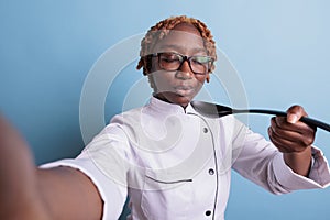 Female chef blowing spoon with hot soup