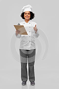 female chef with clipboard showing thumbs up