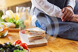 A female chef cooking whole wheat sandwich in kitchen