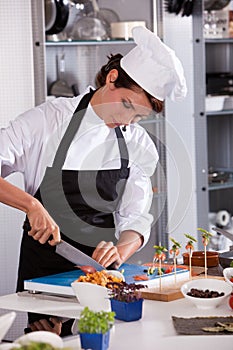 Female chef cutting an onion