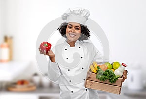 female chef with food in wooden box in kitchen